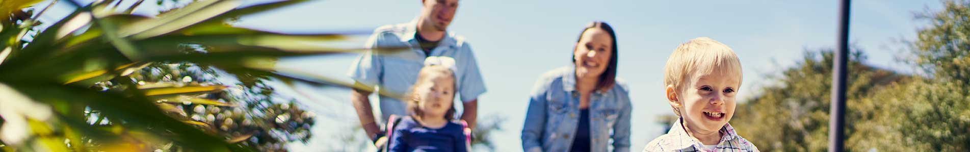 a family in a park with small children