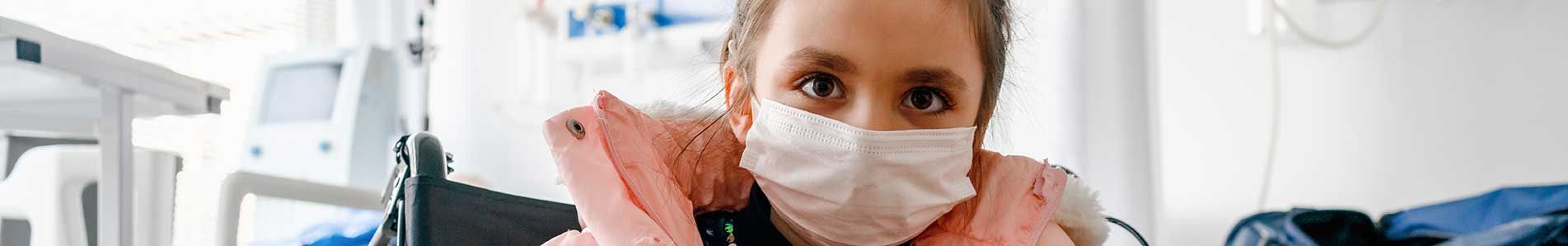 young girl with a mask on in a hospital